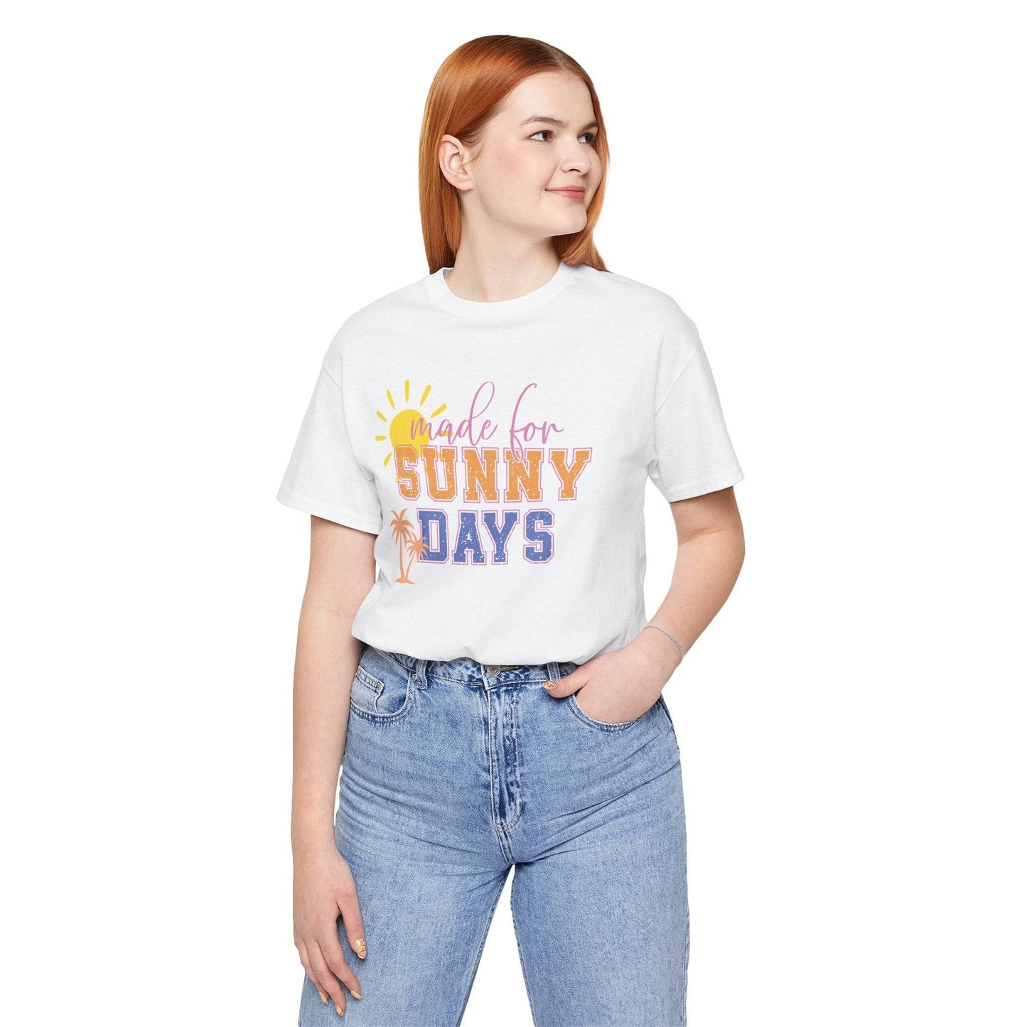 Unisex Made for Sunny Days T-Shirt in white with colorful uplifting text and sun graphic, styled with light blue jeans for a casual summer look.